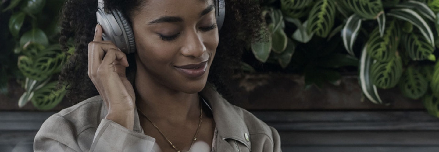 Person listening to Quiet Comfort 35 2 headphones